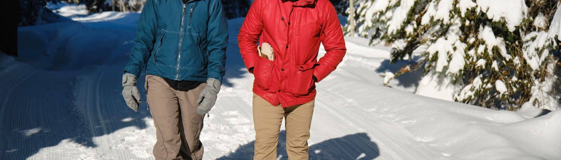 a romantic couple hiking in the woods in winter