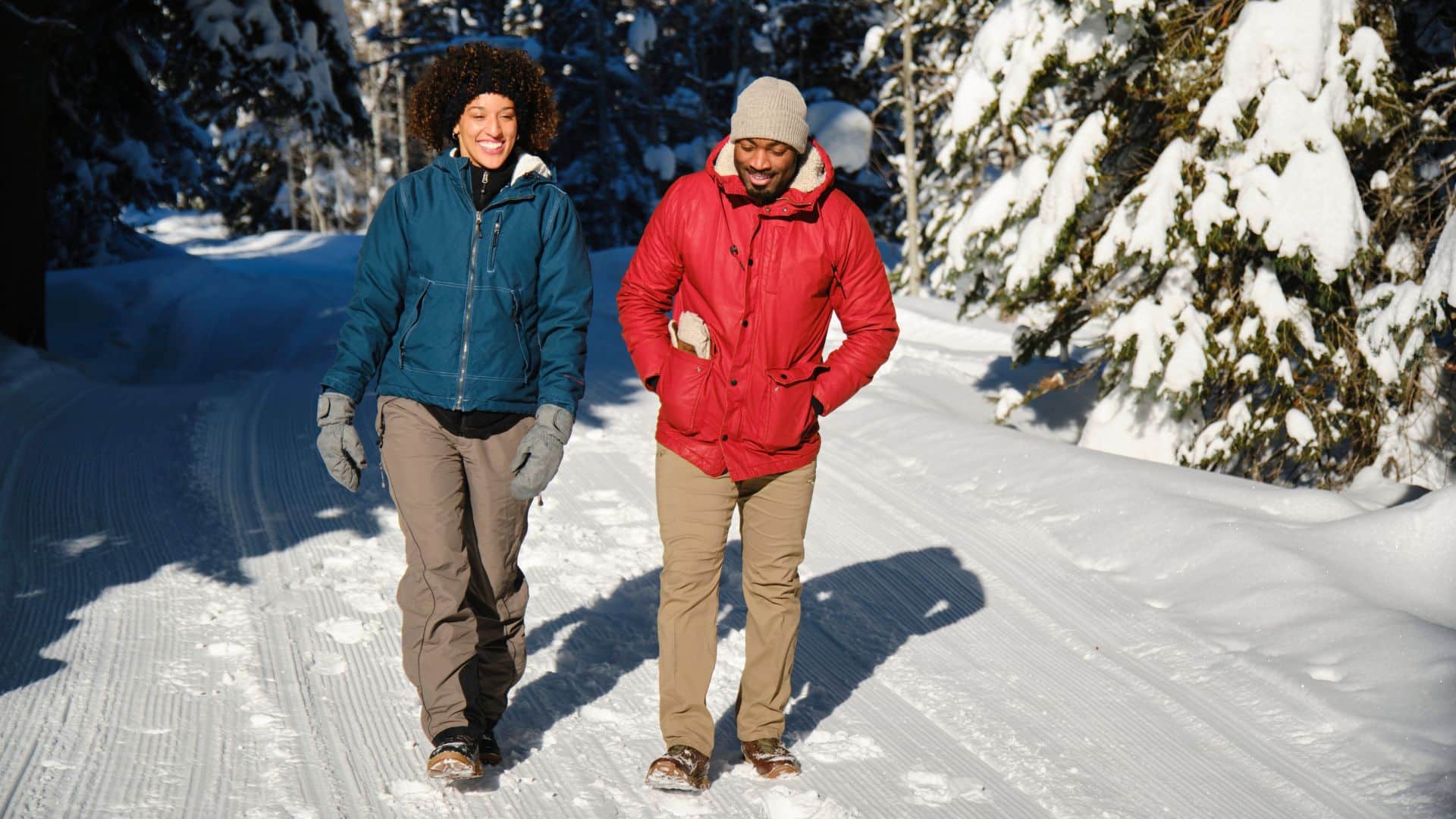 a romantic couple hiking in the woods in winter