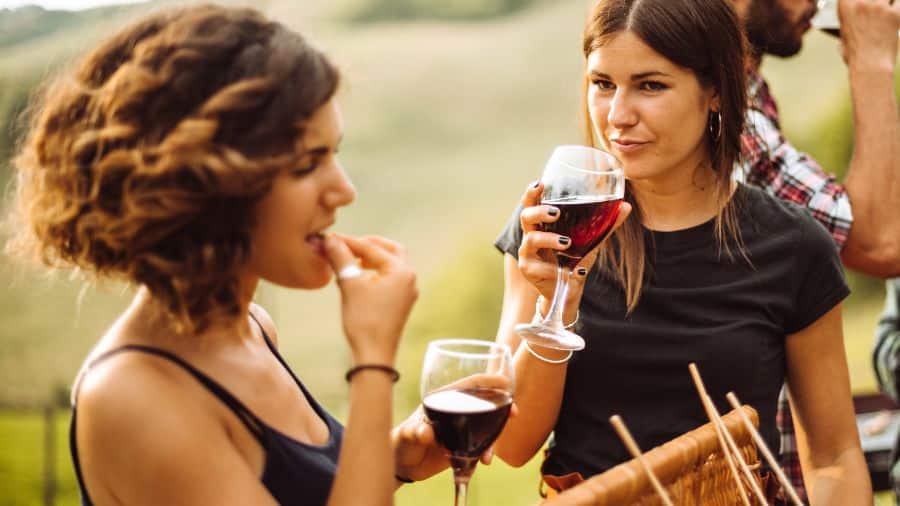 People enjoying a wine tasting while eating snacks 